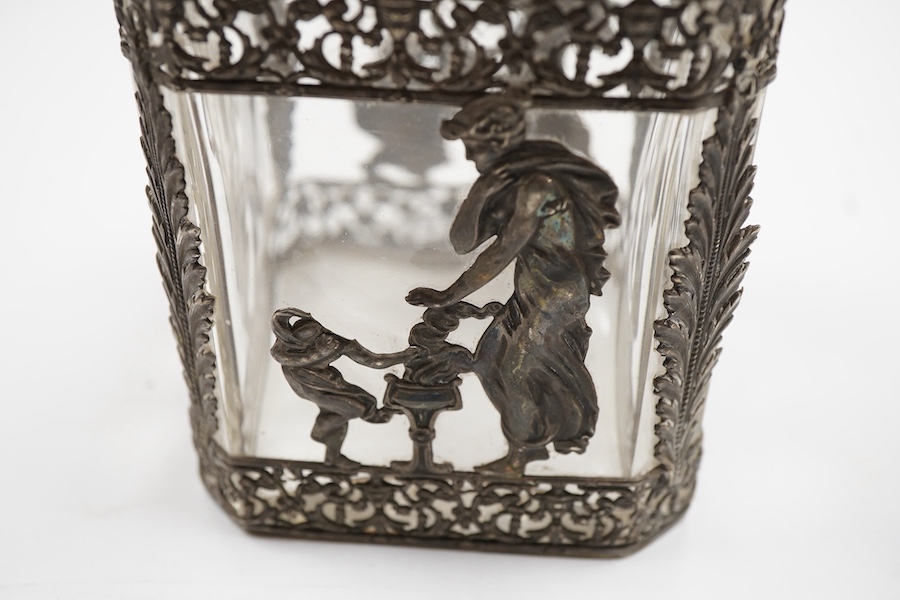 A late 19th/early 20th century French 800 standard pierced white metal mounted glass jar or tea caddy and stopper, decorated with classical scene of a lady with child, height 13.2cm.